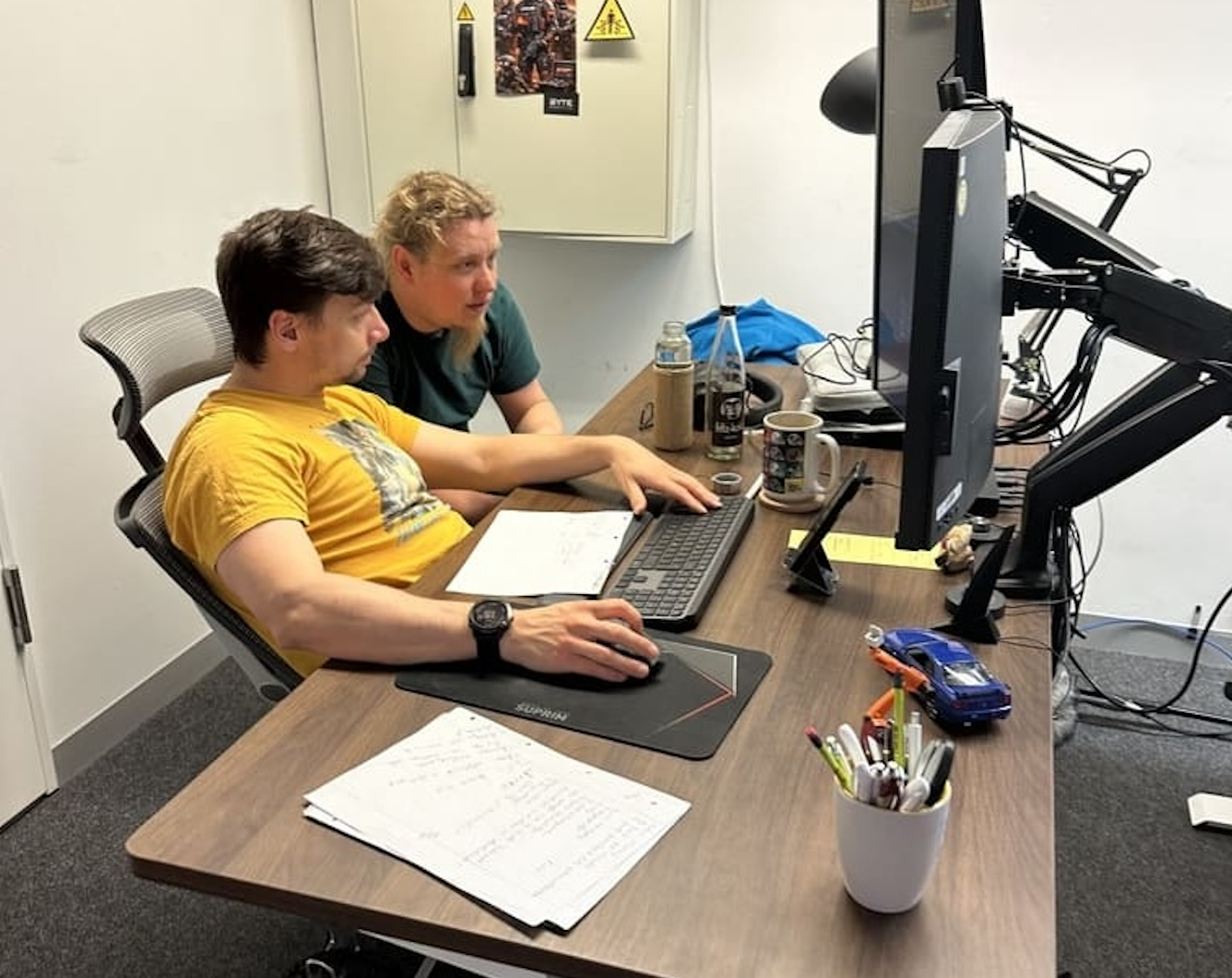 Software developers collaborating at a workstation